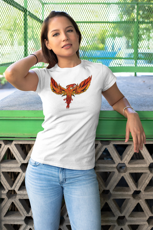Woman wearing white Phoenix Tee with vibrant fiery phoenix design, casual outdoor setting.
