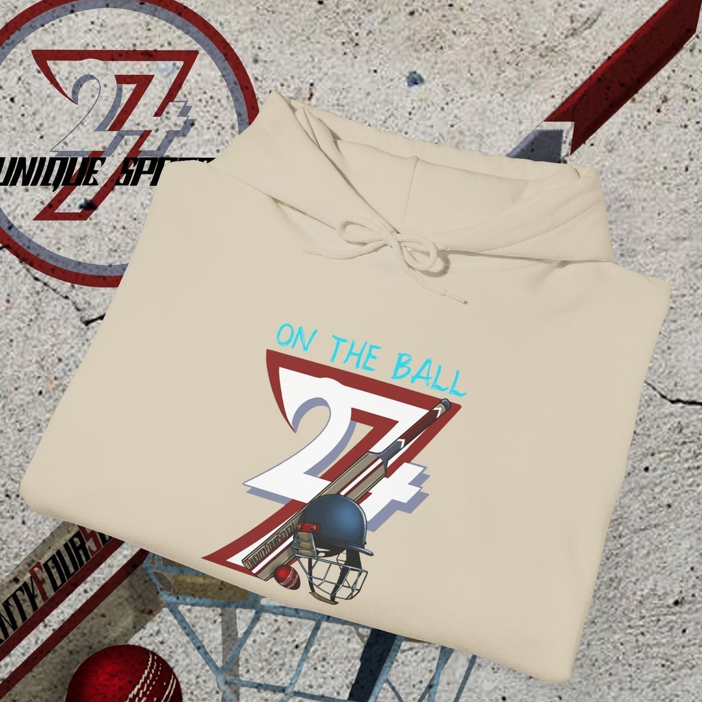 Beige cricket hoodie sweatshirt with unique "On The Ball 24/7" illustration, cricket bat, ball, and helmet design for sport lovers
