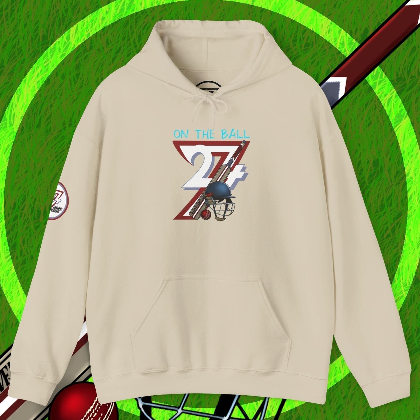 Beige cricket hoodie sweatshirt with unique cricket illustration and kangaroo pocket on green grass background with cricket bat, ball, and helmet.