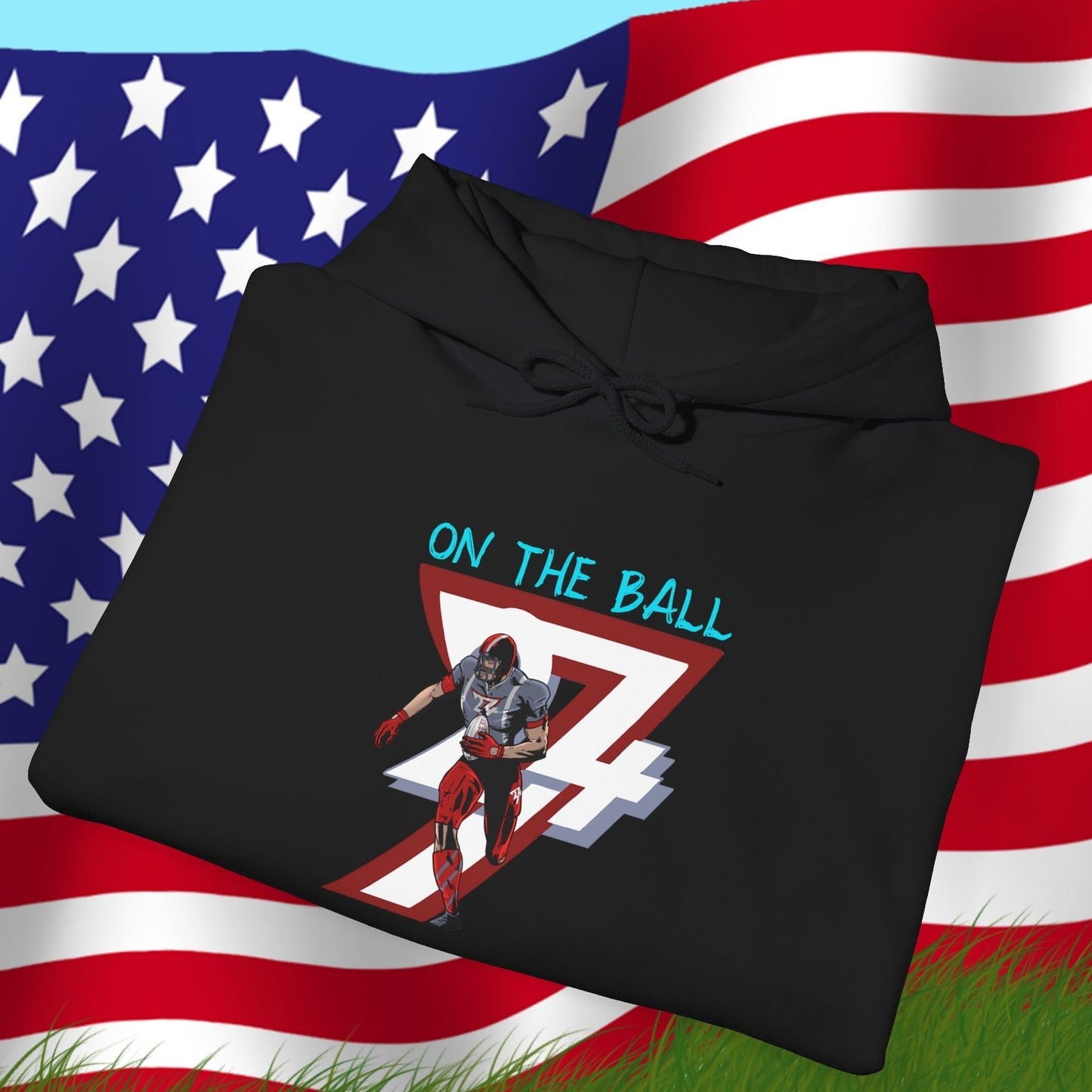 Black american football hoodie with hand-drawn player and "On the Ball" text, displayed on American flag background