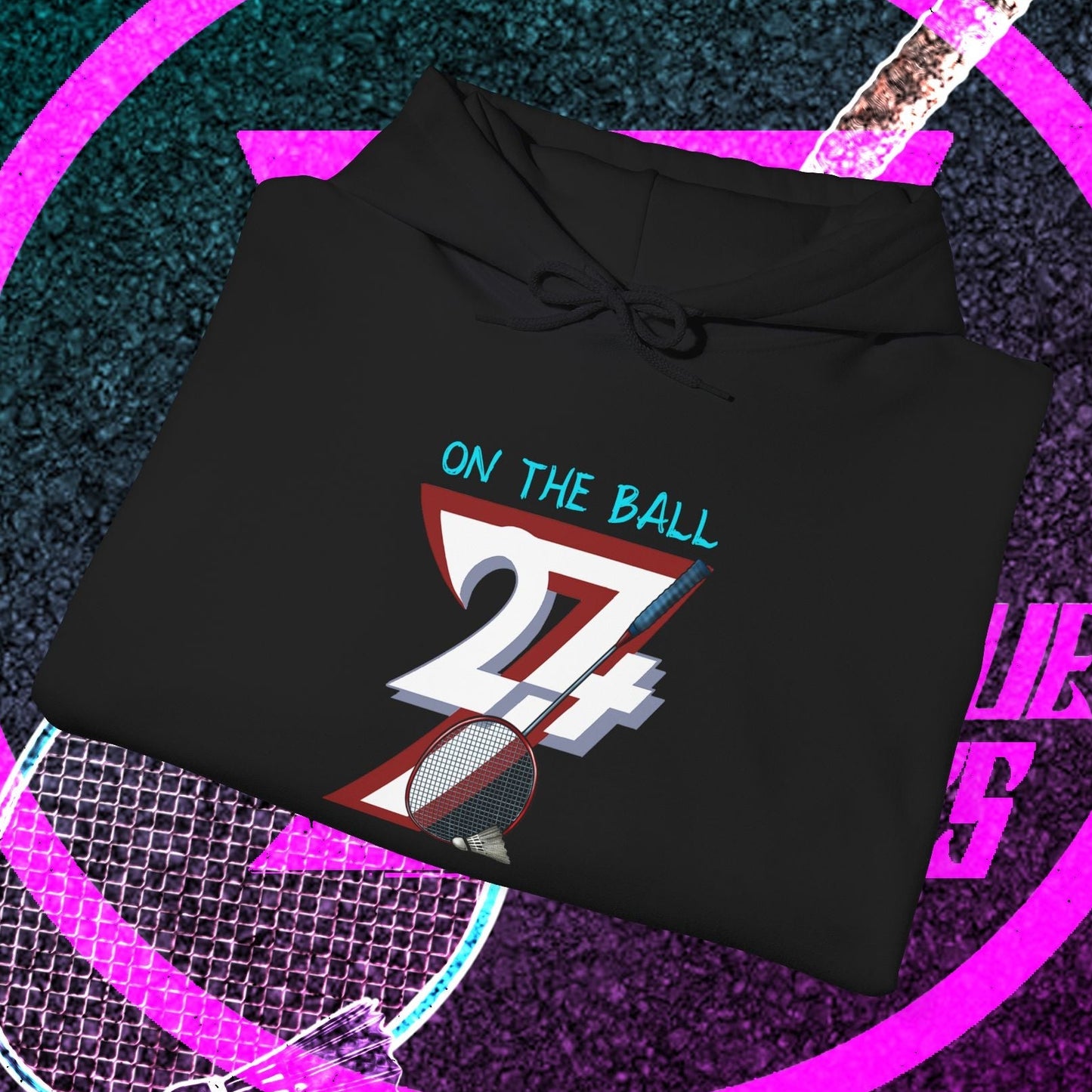 Black badminton hoodie with colorful "On The Ball 24/7" graphic, adjustable drawstring hood, and kangaroo pocket, perfect for outdoor sports and gifts.