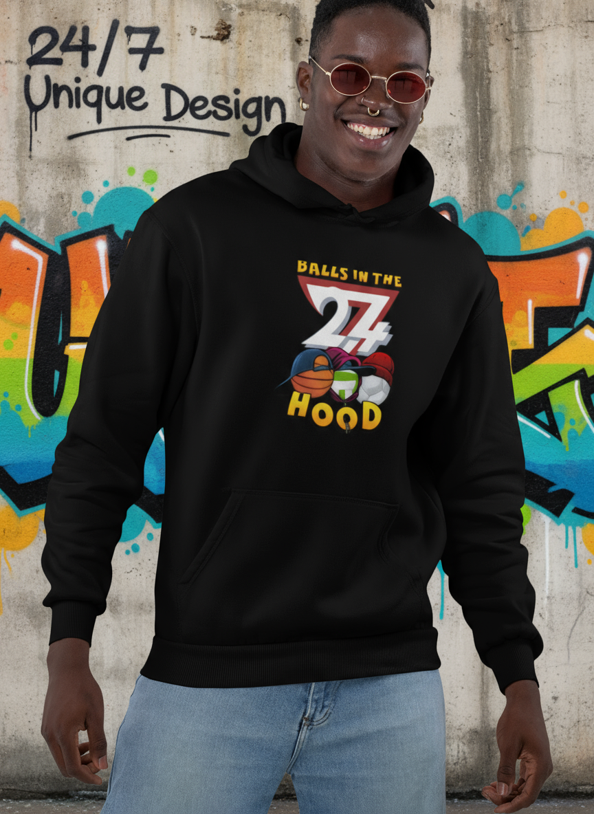 Black printed hoodie with "Balls in the Hood" graphic, worn by smiling man, urban streetwear style