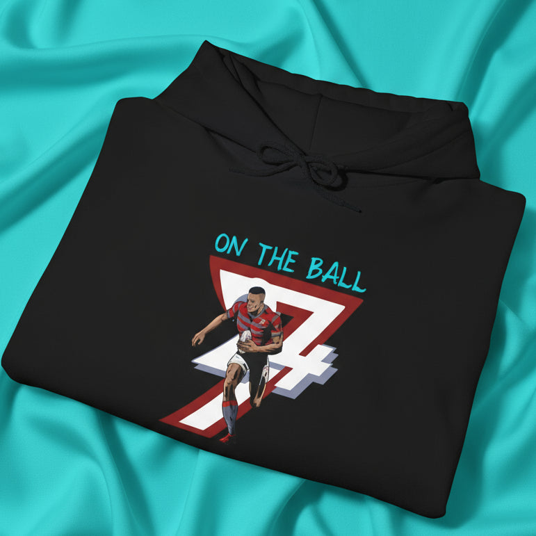 Black rugby hoodie with vibrant hand-drawn rugby player and "On The Ball" text design