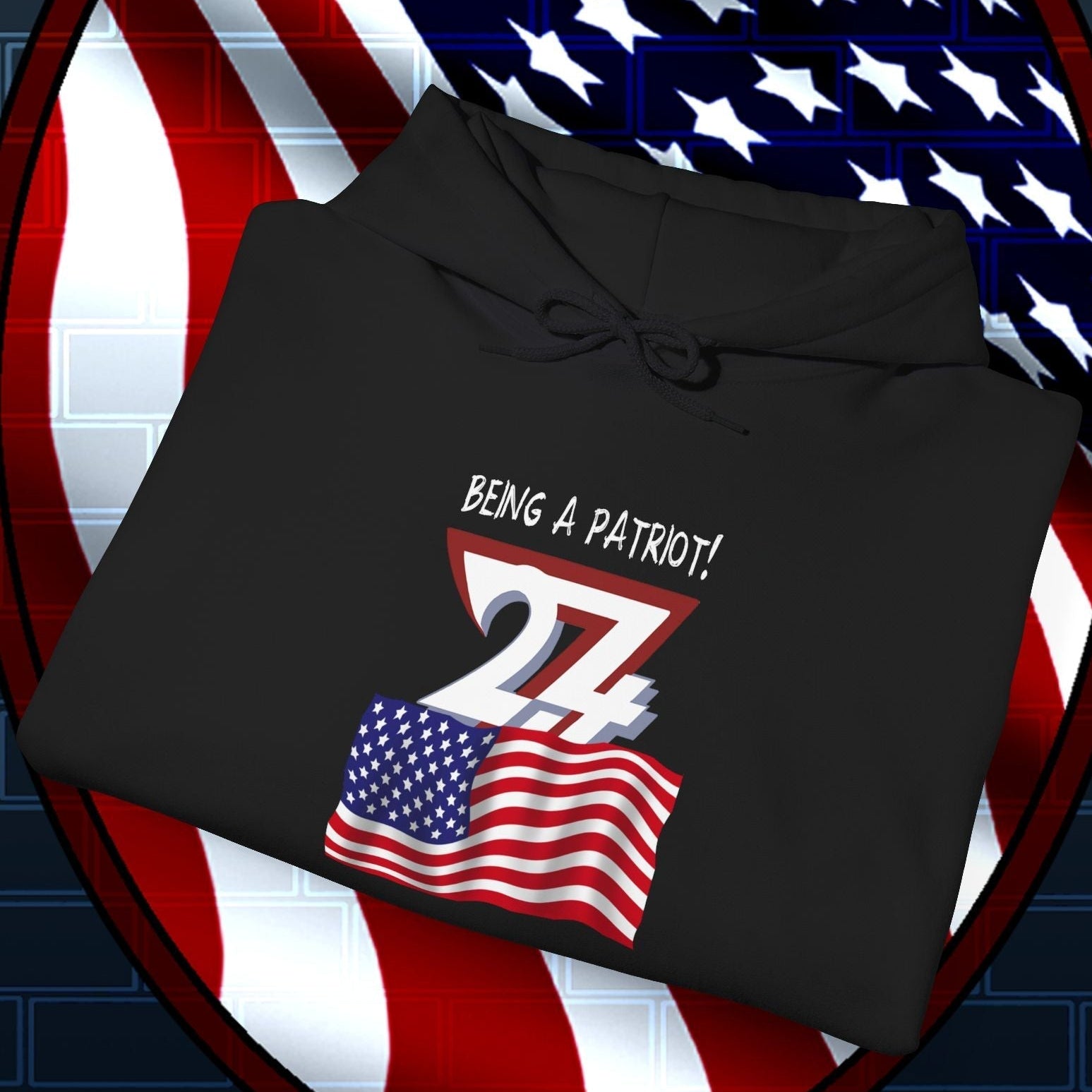 Black usa flag hoodie with hand-drawn American flag and "Being a patriot!" text, folded on American flag shield background
