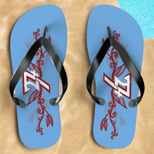 Blue summer flip flops with vibrant floral design, top view showing the colorful pattern on footbed