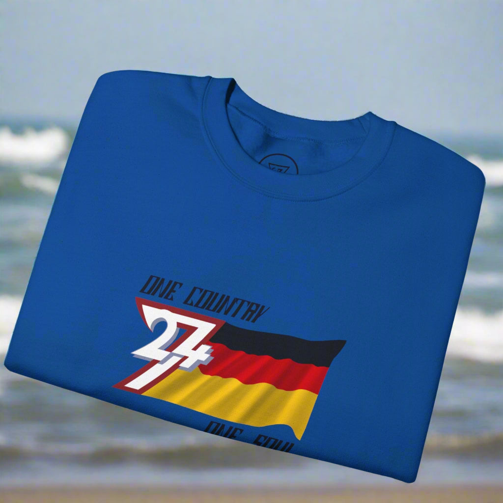 Folded blue sweatshirt with a graphic design of the Germany flag by 24/7 Unique Designs