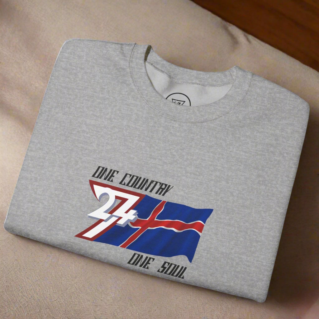 Folded gray crewneck sweatshirt featuring a hand-drawn Iceland flag with "One country one soul" slogan on front