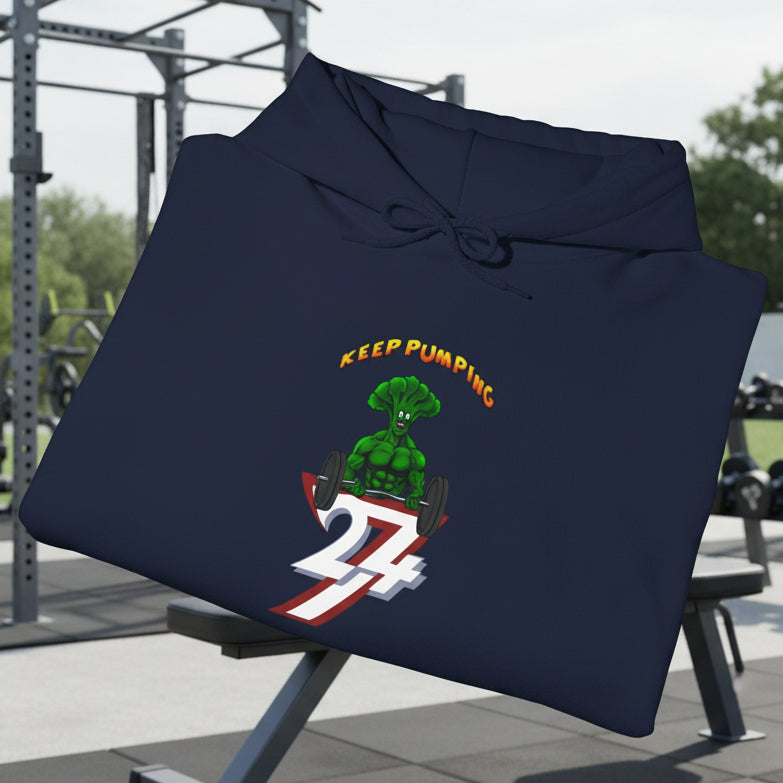 Folded navy blue broccoli hoodie with cartoon bodybuilder graphic and "Keep Pumping" text