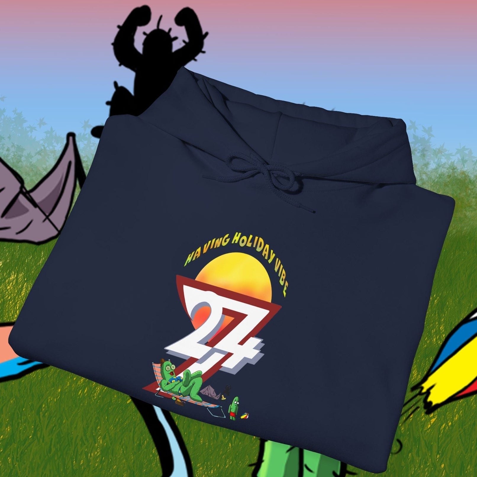 Folded navy blue cactus hoodie with cartoon character and "Holiday Vibe 24" design on front, camping background
