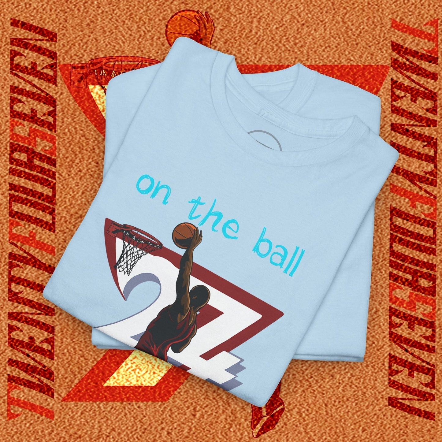 Light blue 90s comic-style basketball tee with hand-drawn dunk graphic and "on the ball" text, soft cotton streetwear shirt.