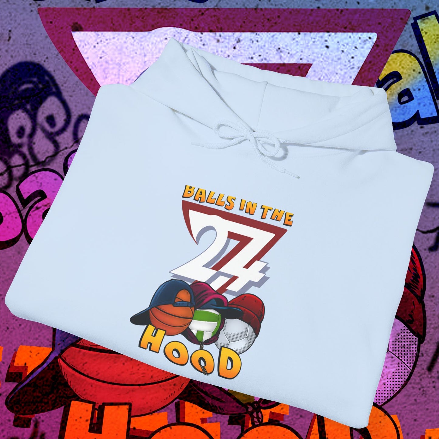 Light blue printed hoodie with sports balls graphic and "Balls in the Hood" text on front, urban streetwear style for ballgames and city nights