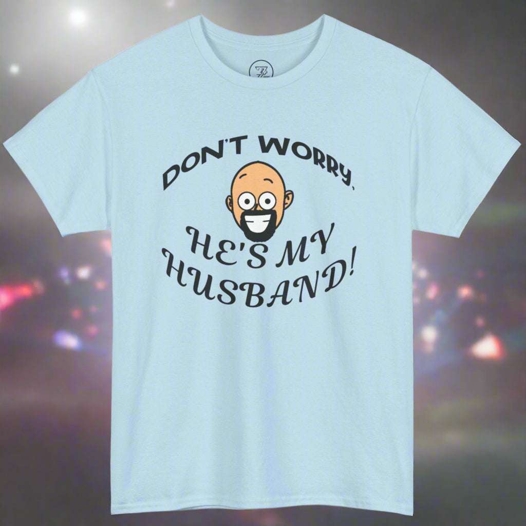 Light blue unisex cotton T-shirt with "Don't Worry, He's My Husband!" kiss cam funny quote and smiling cartoon face design.