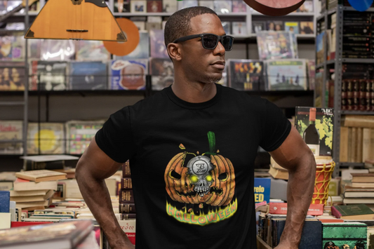 Man wearing black Pumpkin Skull Halloween tee with glowing eyes design standing in a bookstore