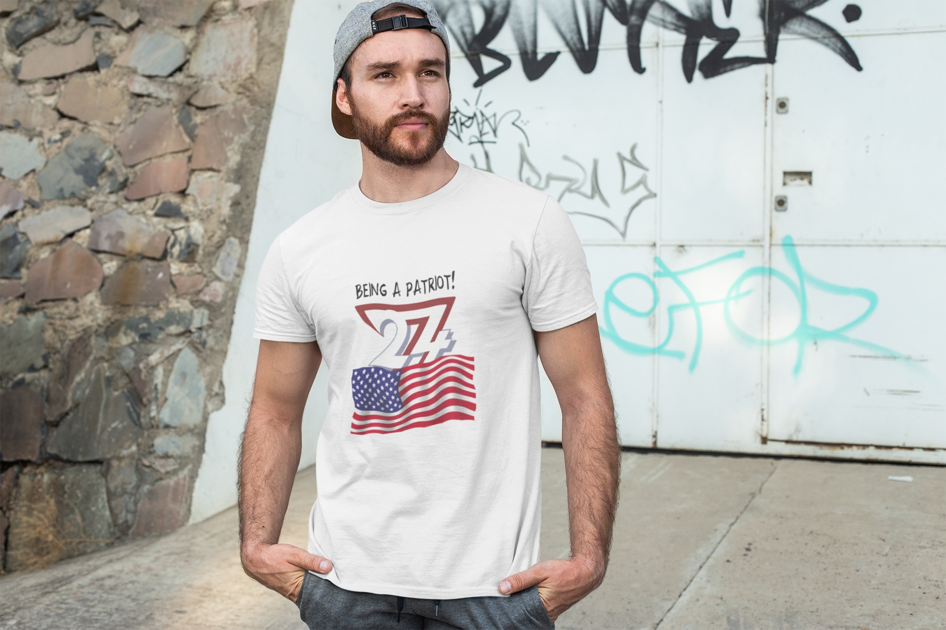 Man wearing white USA Flag t-shirt with patriotic design and text "Being a Patriot!" outdoors