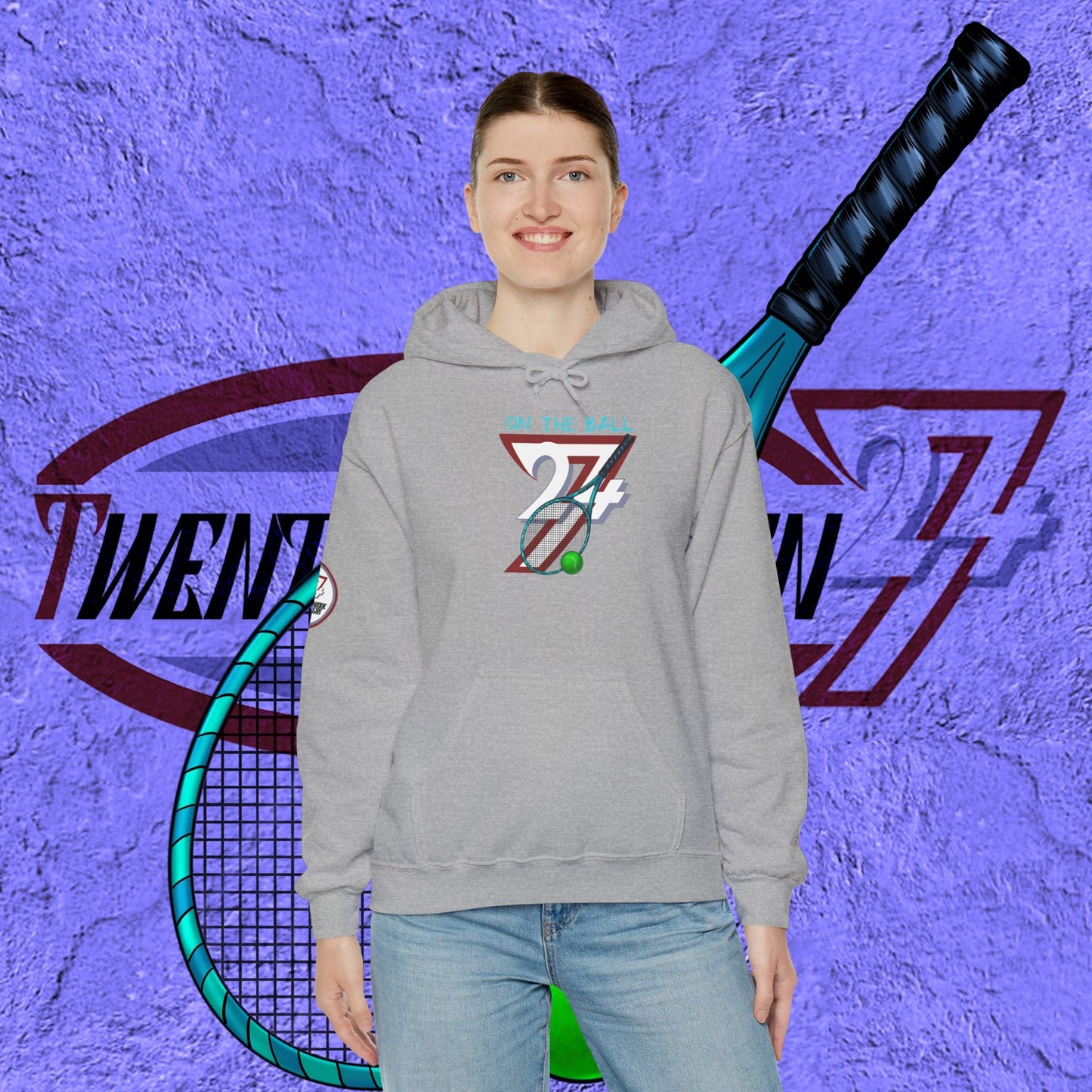 Person wearing a gray tennis hoodie with a logo