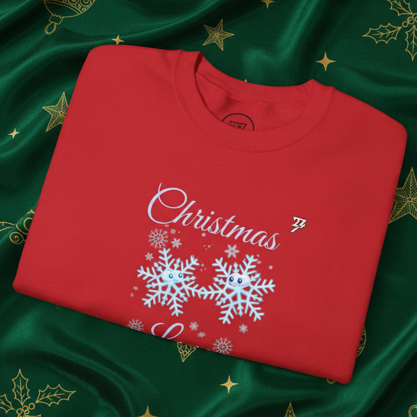 Red Christmas sweatshirt with cute snowflakes design and festive text on a green holiday-themed background