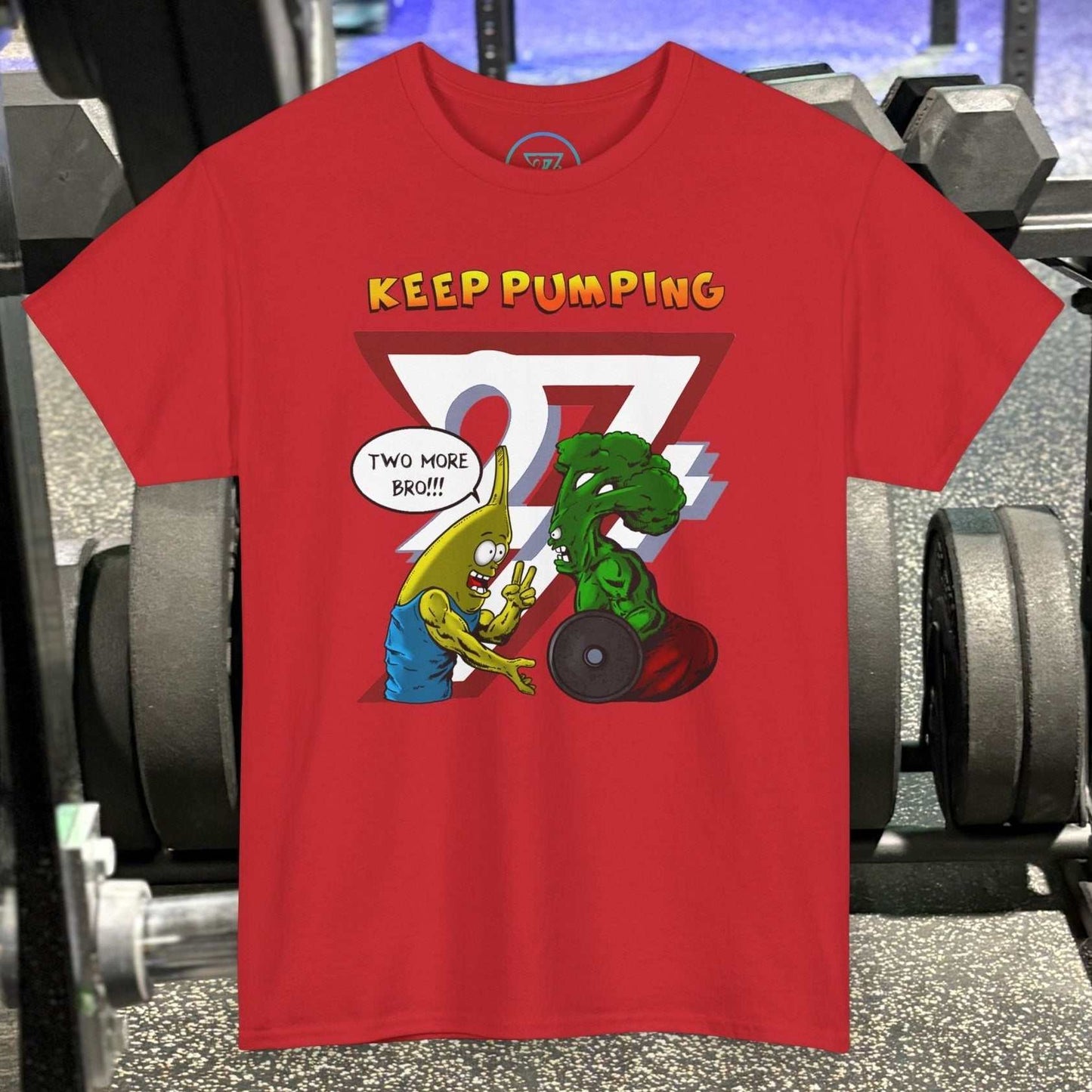 Red broccoli gym tee with cartoon banana and broccoli characters lifting weights and "Keep Pumping" text