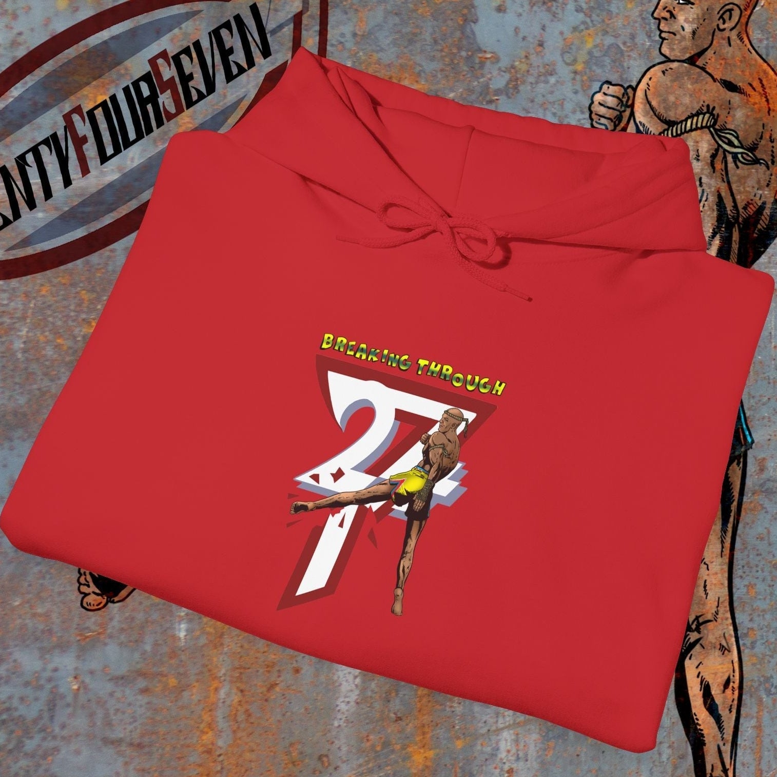 Red muay thai hooded sweatshirt with "Breaking Through 247" graphic and martial artist illustration on textured background
