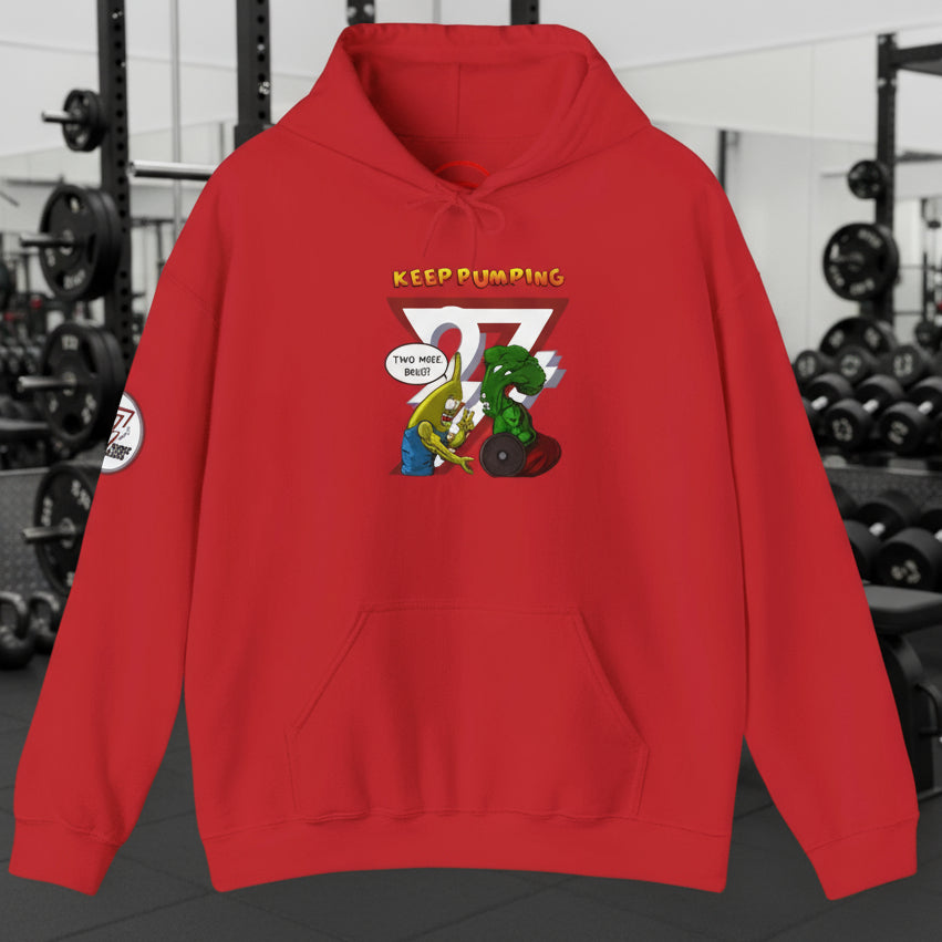 Red workout hoodie with cartoon broccoli and banana lifting weights illustration and "Keep Pumping" text