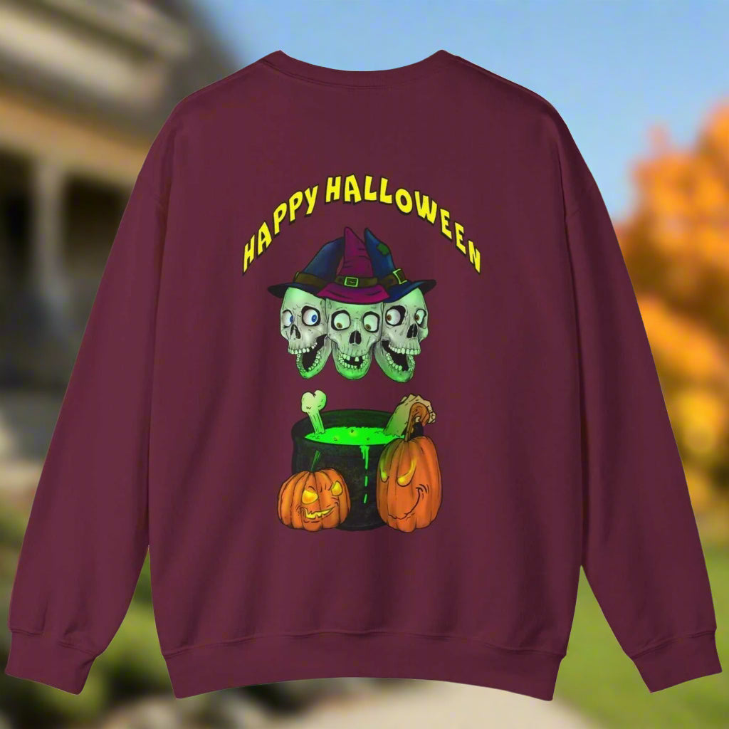 Maroon Halloween sweatshirt featuring three skulls with witch hats and a bubbling green cauldron with pumpkins, perfect for spooky celebrations.