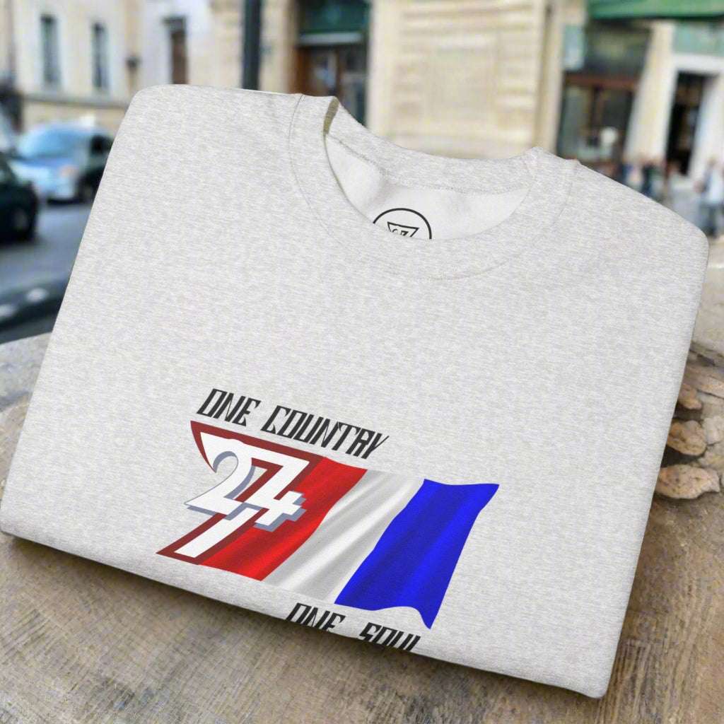 Folded grey unisex sweatshirt with hand-drawn France flag and "One Country One Soul" slogan graphic.