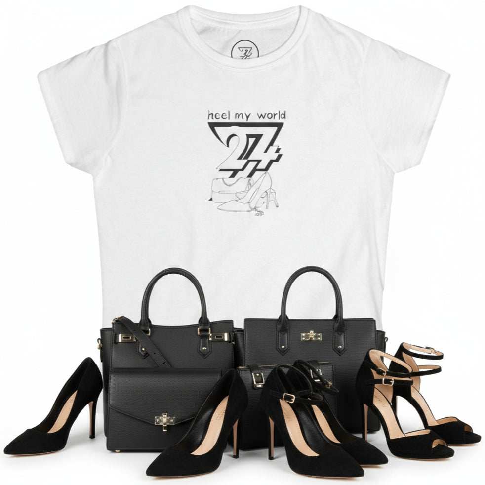 White graphic tee for women with "heel my world" quote and black outline design of handbag and high heels