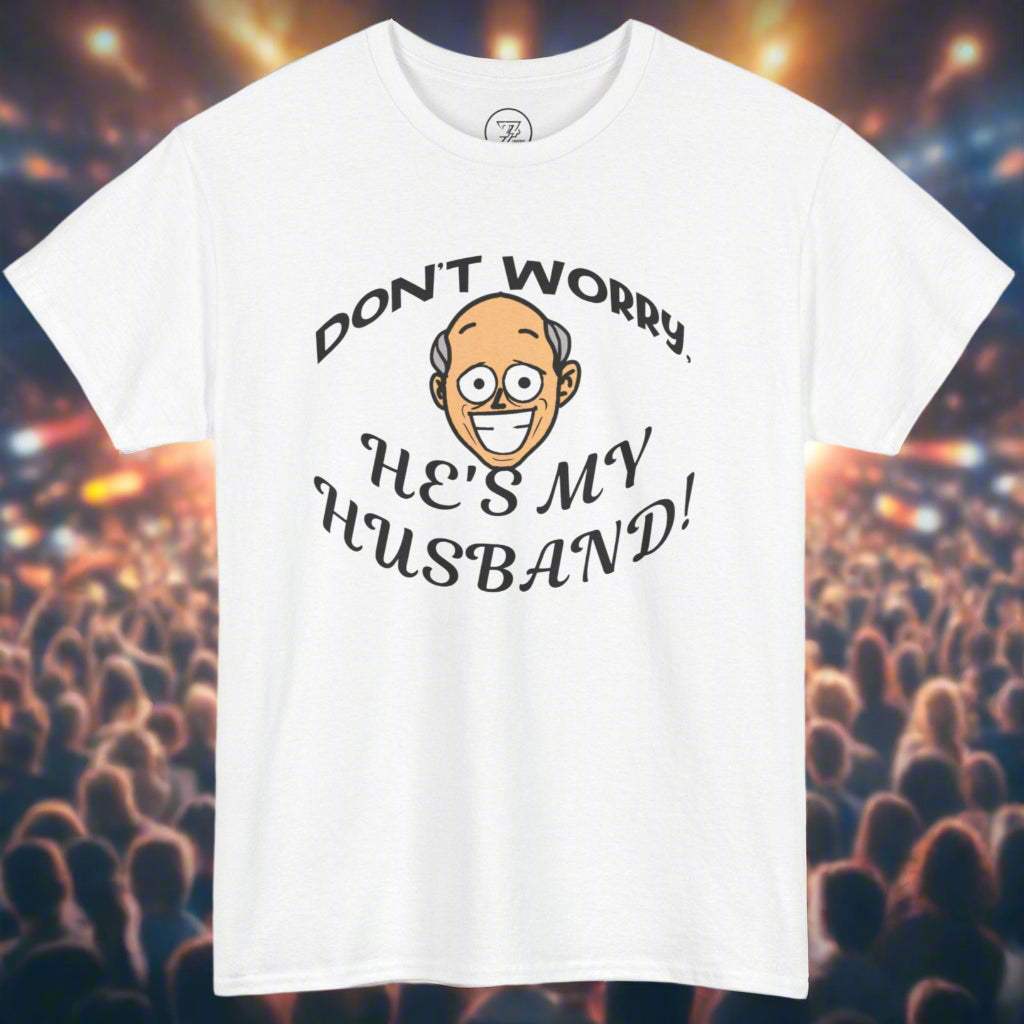 White unisex Kiss Cam T-shirt with funny "Don't worry, he's my husband!" quote and cartoon face, perfect for concert goers.