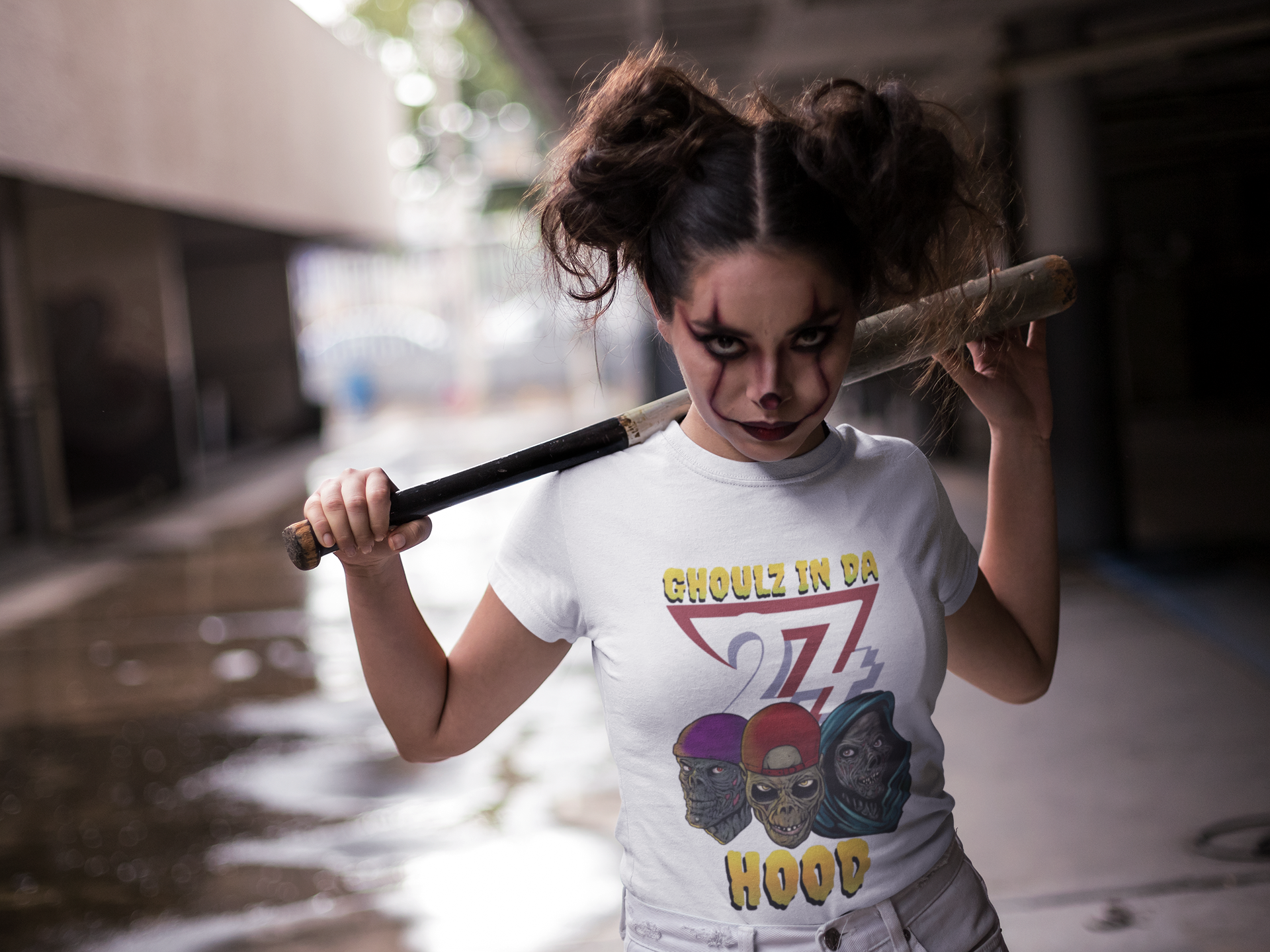 White zombie tee with colorful ghouls in hoodies and "Ghoulz in da Hood" text, urban Halloween design.