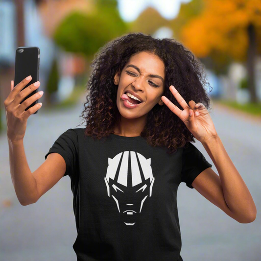 Woman wearing black devil shirt with comic character head design taking a selfie outdoors