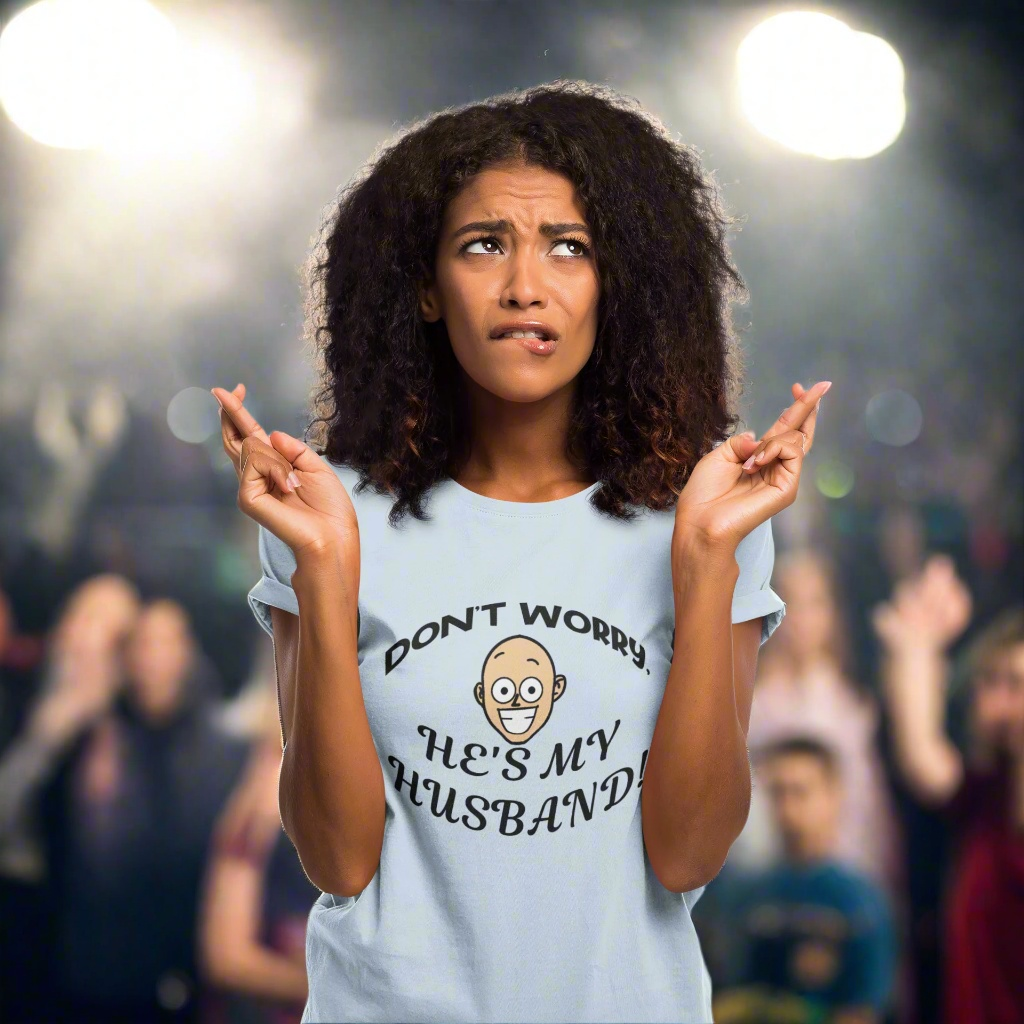 Woman wearing white Kiss Cam Safe Tee with funny "Don't worry, he's my husband" quote at concert