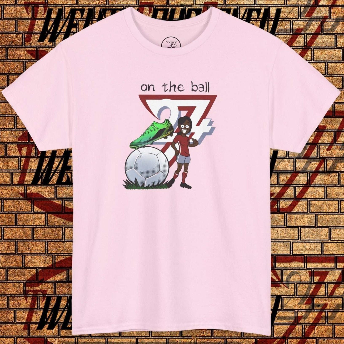 Women's pink soccer t-shirt with hand-drawn football boot graphic and "on the ball" text