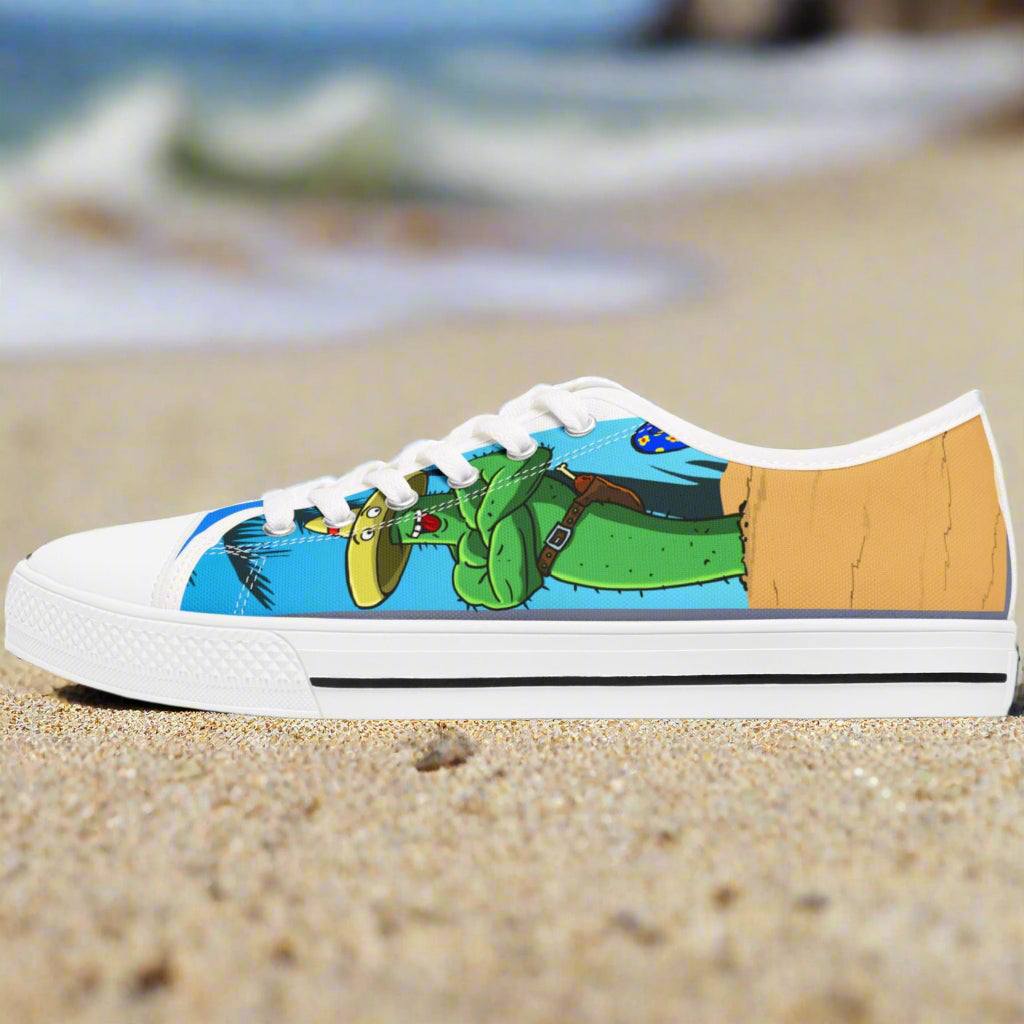 White low top sneaker with colorful cartoon cactus design on blue background, tropic feel sneakers for women.