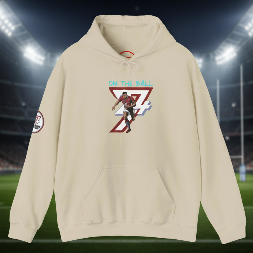 beige rugby hoodie with hand-drawn rugby player design and "On The Ball" text, kangaroo pocket, adjustable drawstring hood