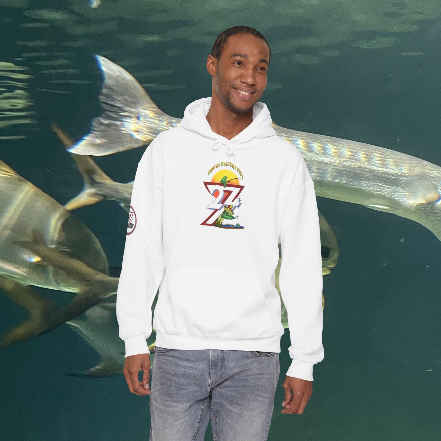 man wearing white Funny Fishing Hoodie with cactus design standing underwater with fish background