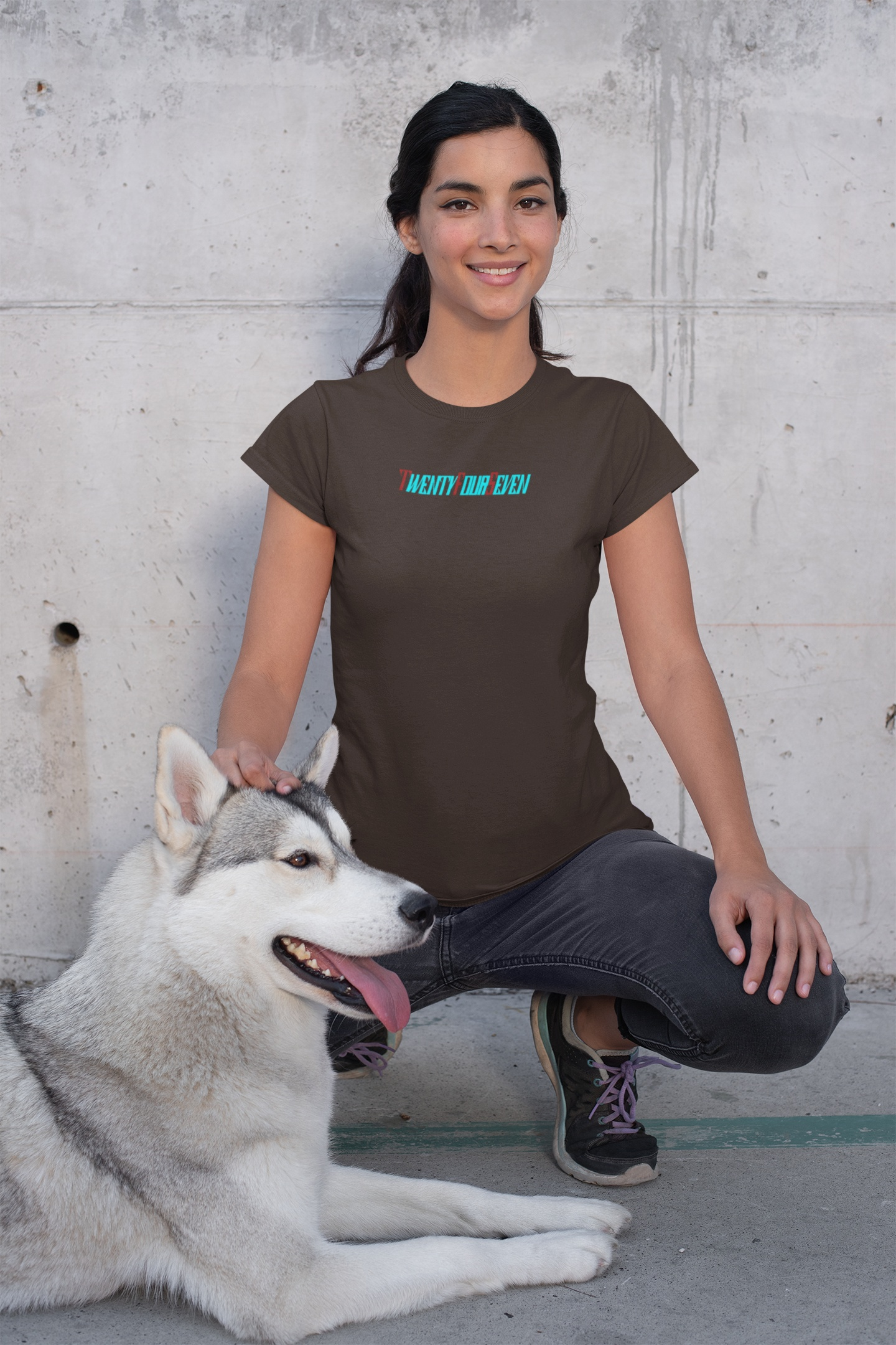 unique women t-shirt with vibrant text worn by smiling woman sitting beside a husky dog outdoors