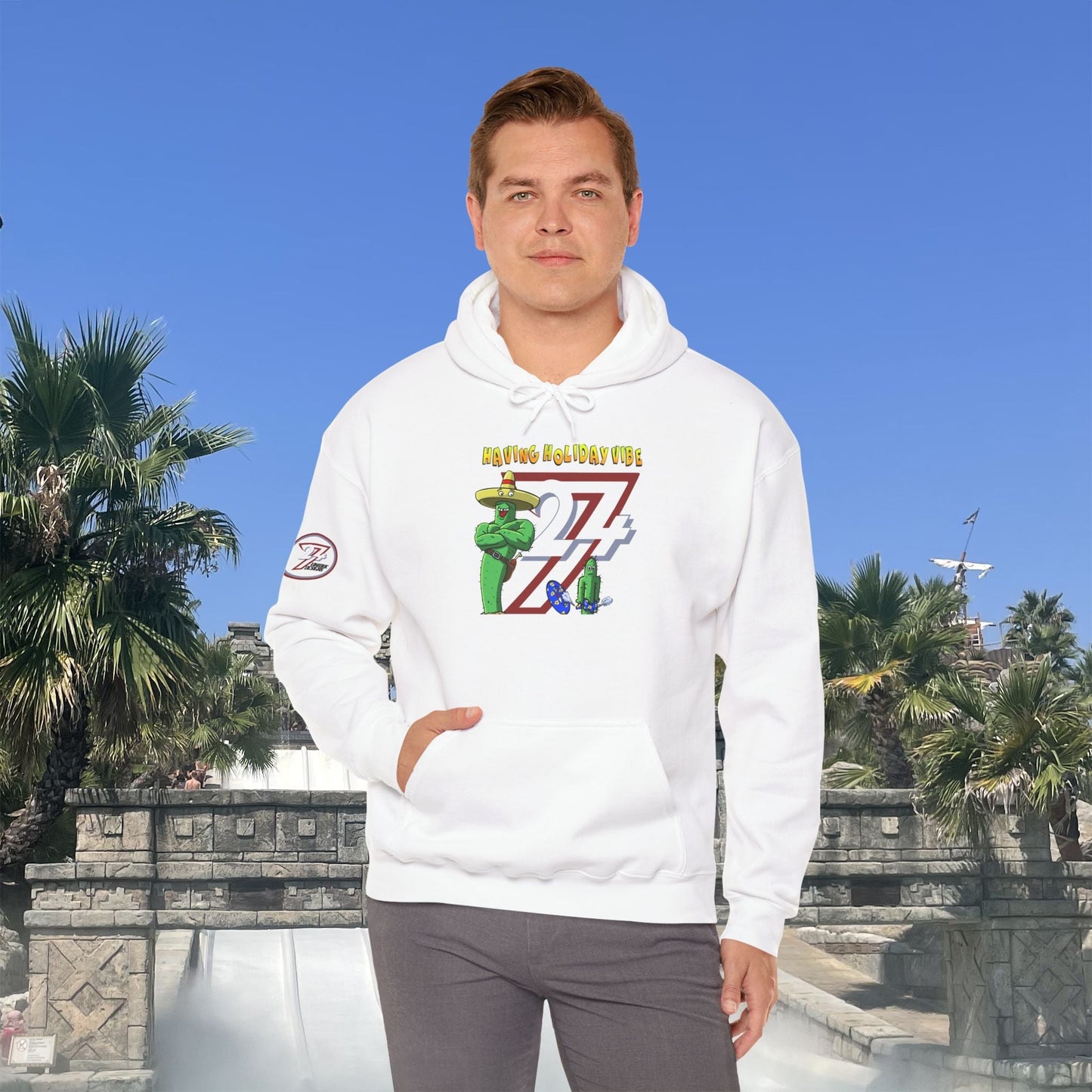 white cactus hoodie with cartoon character and holiday vibe design worn by man outdoors