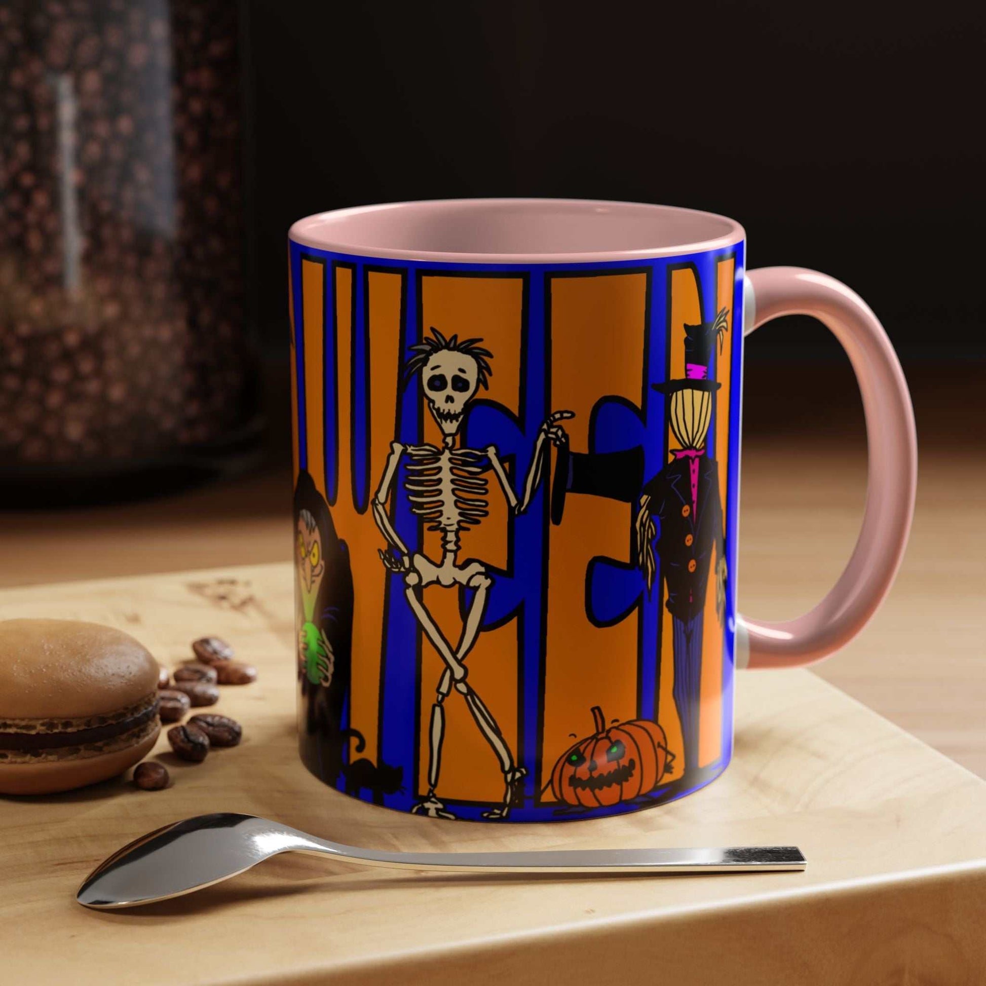 Halloween coffee mug with colorful design on table, available in 11 and 15oz sizes.