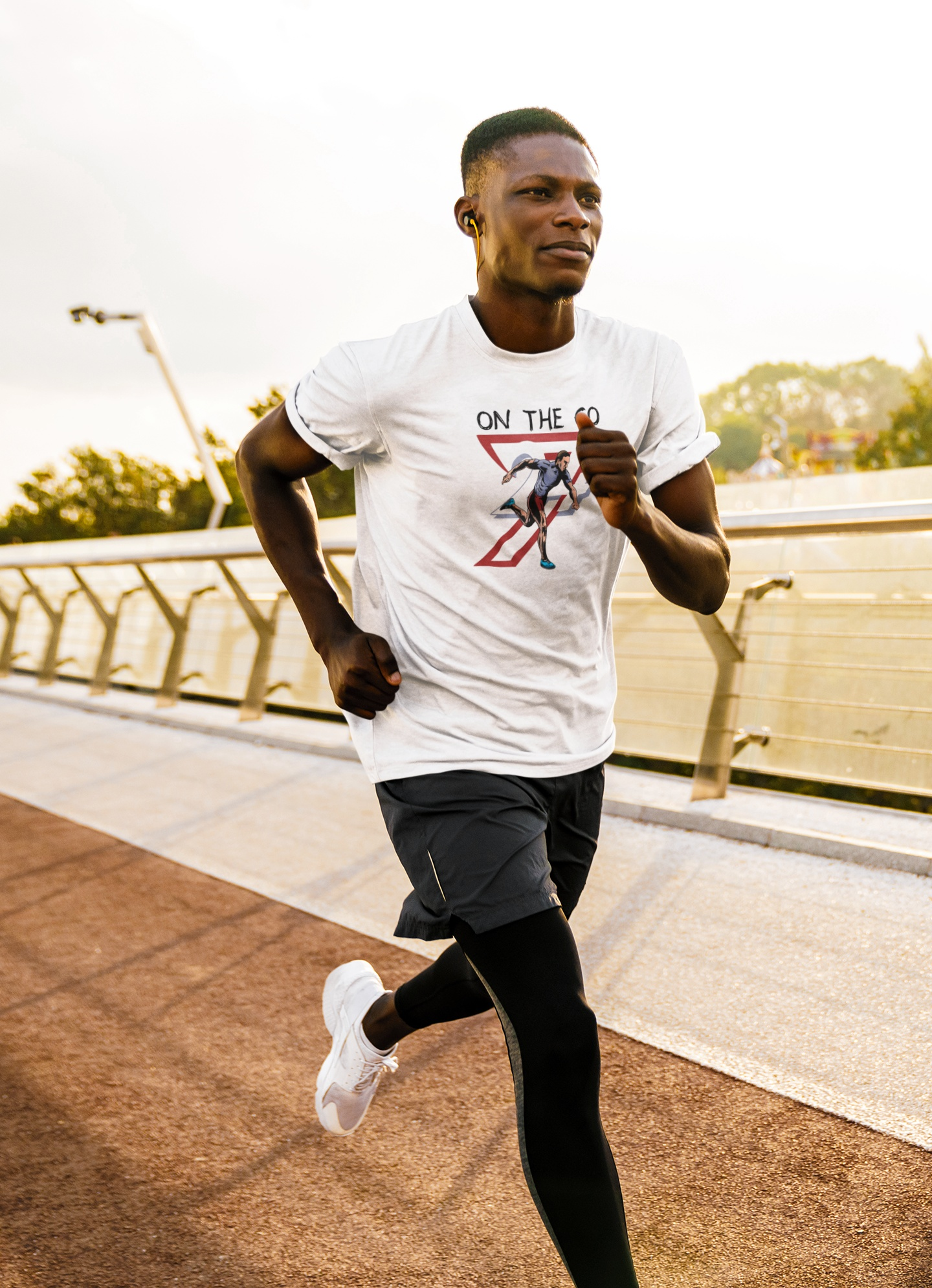 Athlete wearing white running sports tee with hand-drawn runner illustration jogging outdoors