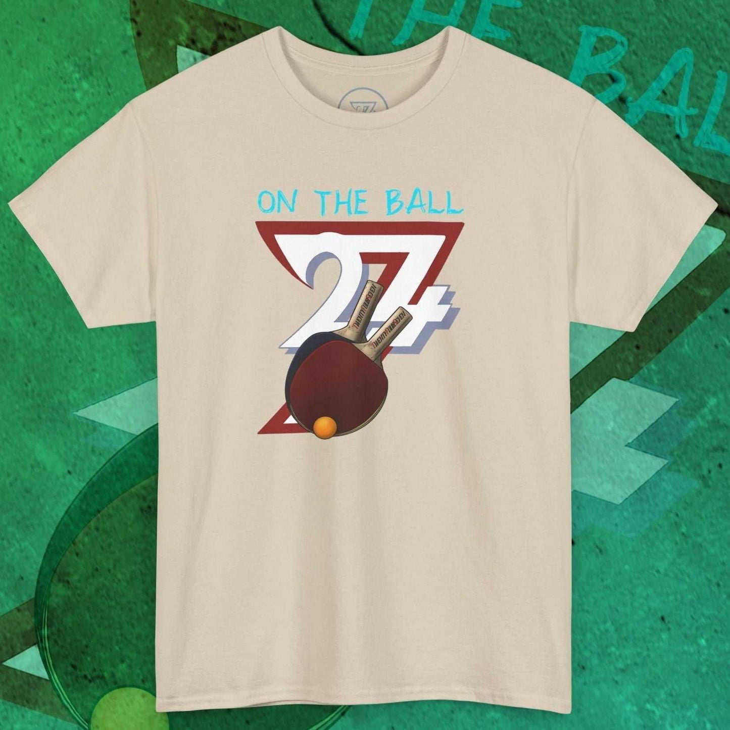 Beige Ping-Pong T-Shirt with hand-drawn paddle and ball illustration and "On The Ball" text design