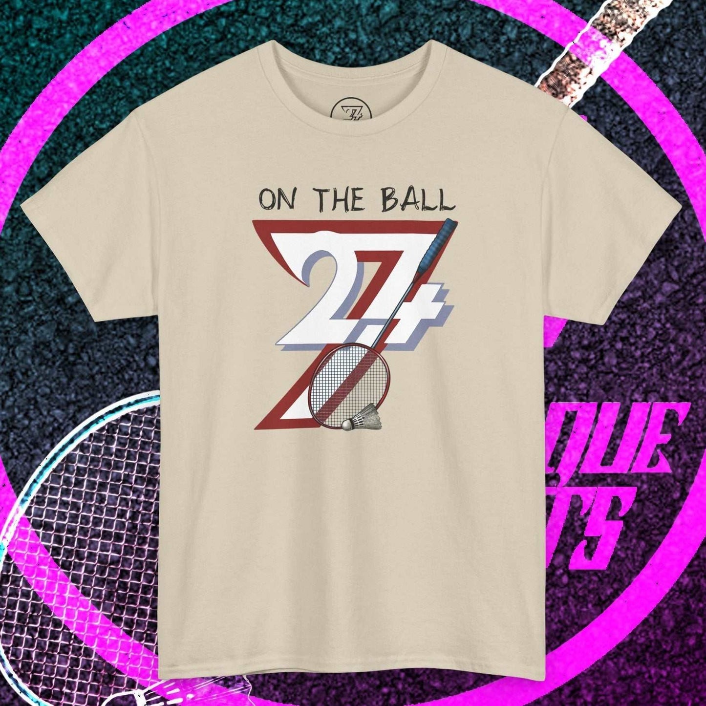 Beige badminton tee with hand-drawn "On the Ball 24/7" design, breathable cotton, and classic fit