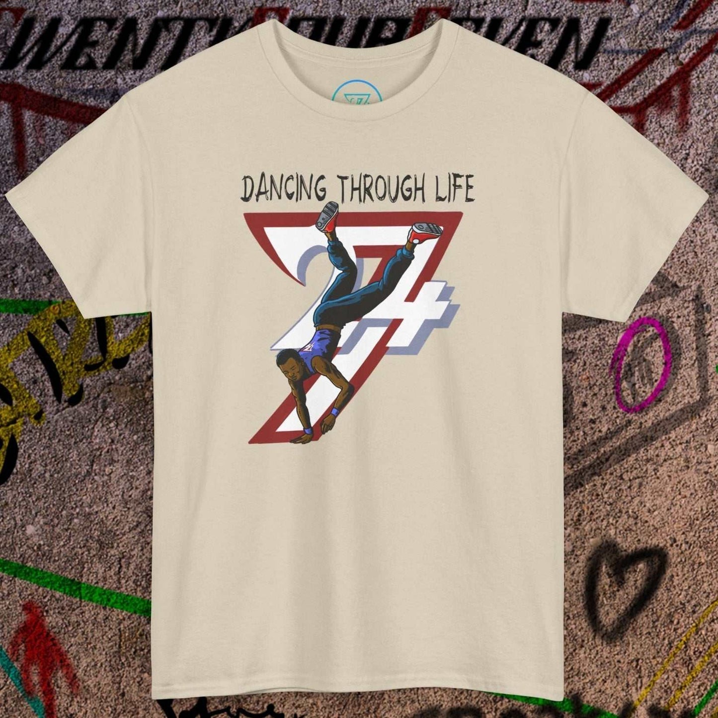 Beige hip-hop dance tee with "Dancing Through Life" text and breakdancer graphic on urban graffiti background