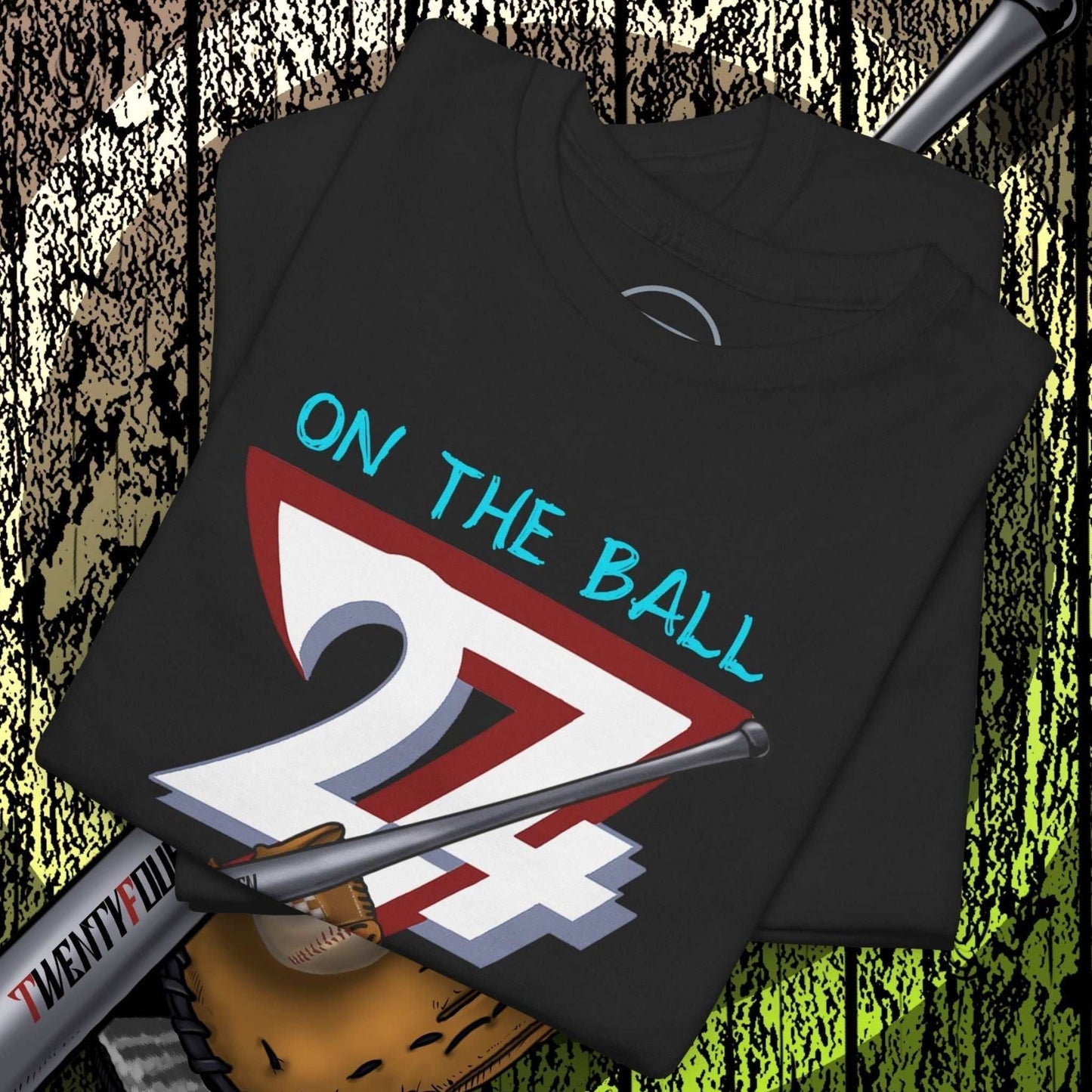 Black Baseball Illustrated Tee with hand-drawn "On The Ball 24/7" design, baseball bat, and glove graphic on wooden background