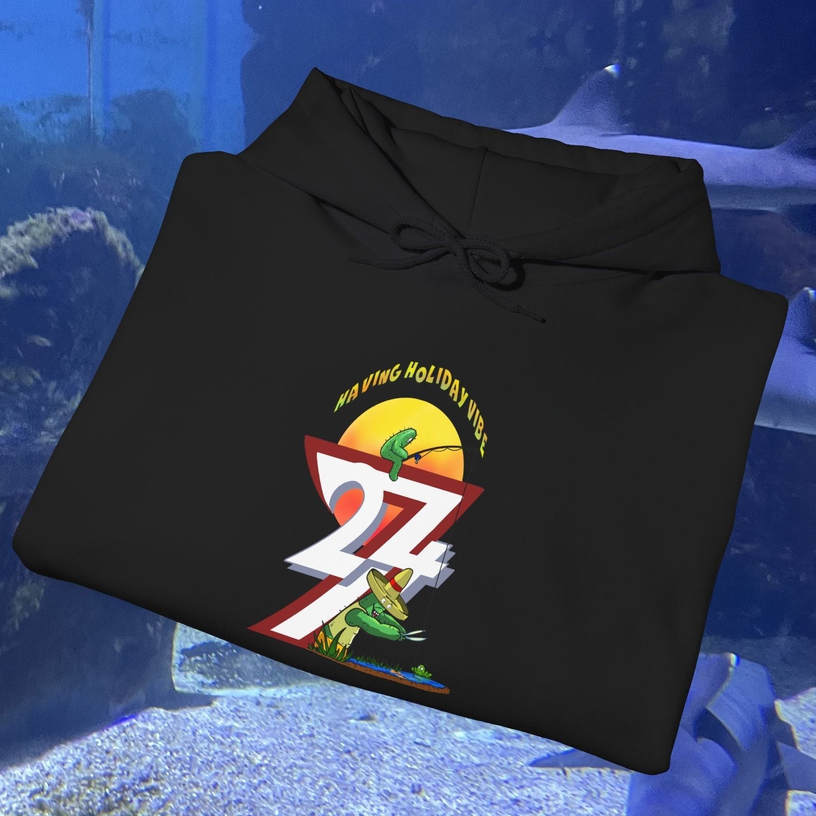 Black Funny Fishing Hoodie with colorful cactus and fishing design, summer holiday theme jumper, folded on aquarium background