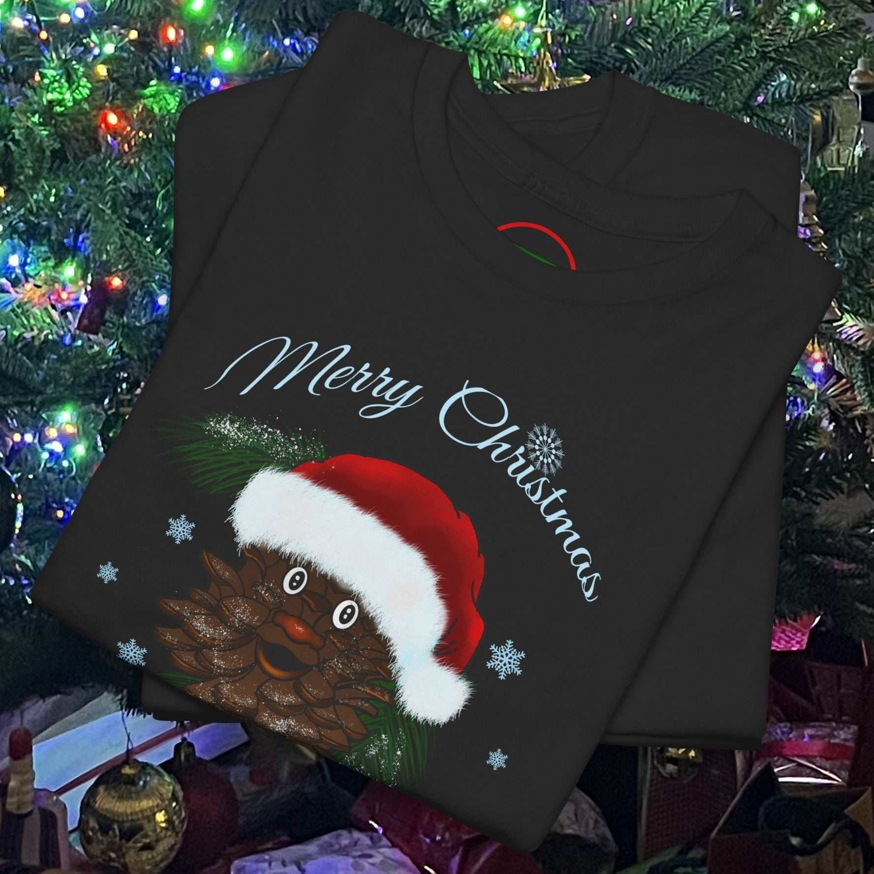 Black Santa Pinecone Tee featuring a cute pinecone character wearing a red Santa hat with "Merry Christmas" text and snowflakes.