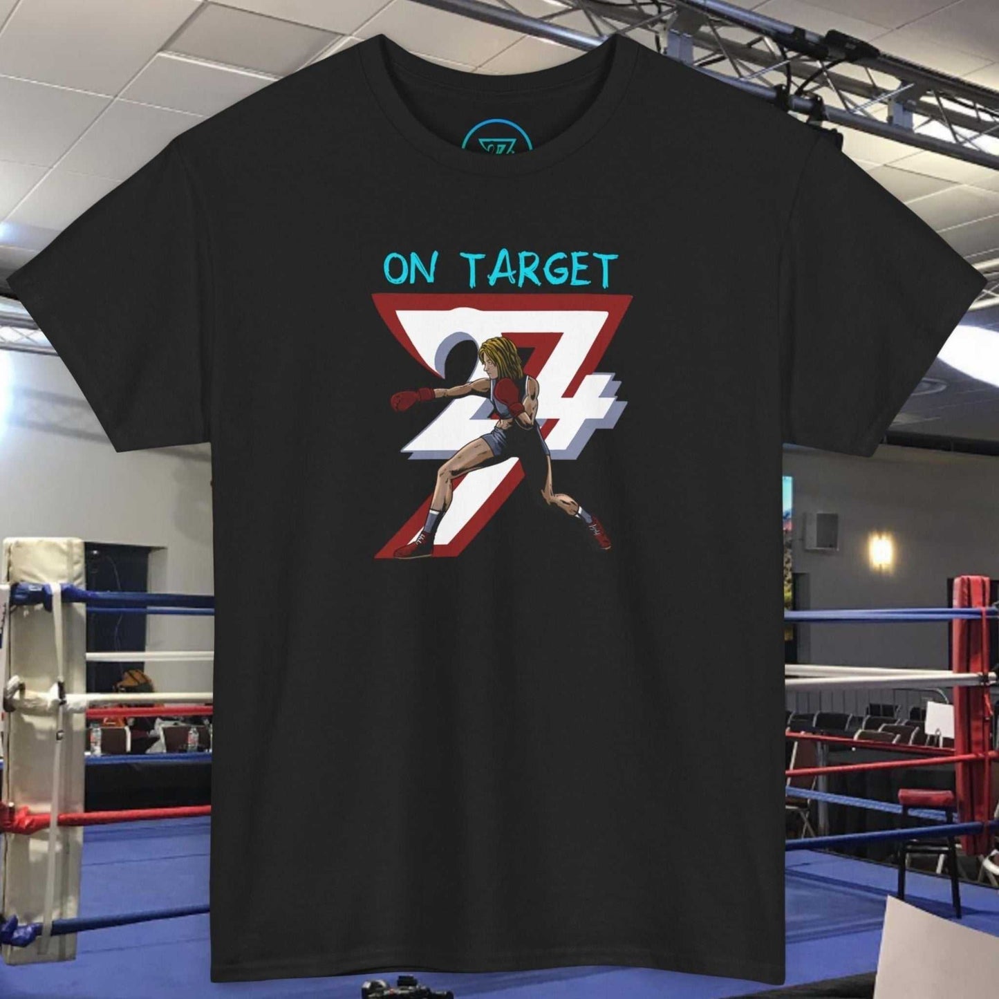 Black boxer girl t-shirt with hand-drawn boxing art and "On Target 24/7" print, displayed in a boxing gym.