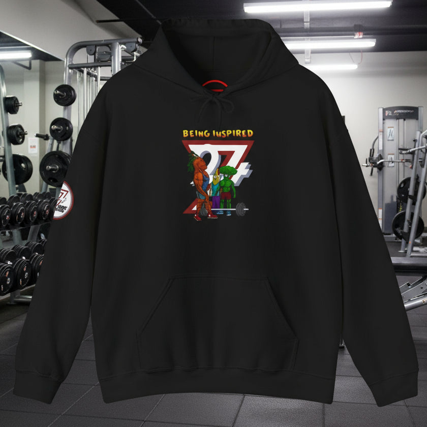 Black custom hoodie with banana and broccoli comic characters and "Being Inspired" text, kangaroo pocket, adjustable drawstring hood.