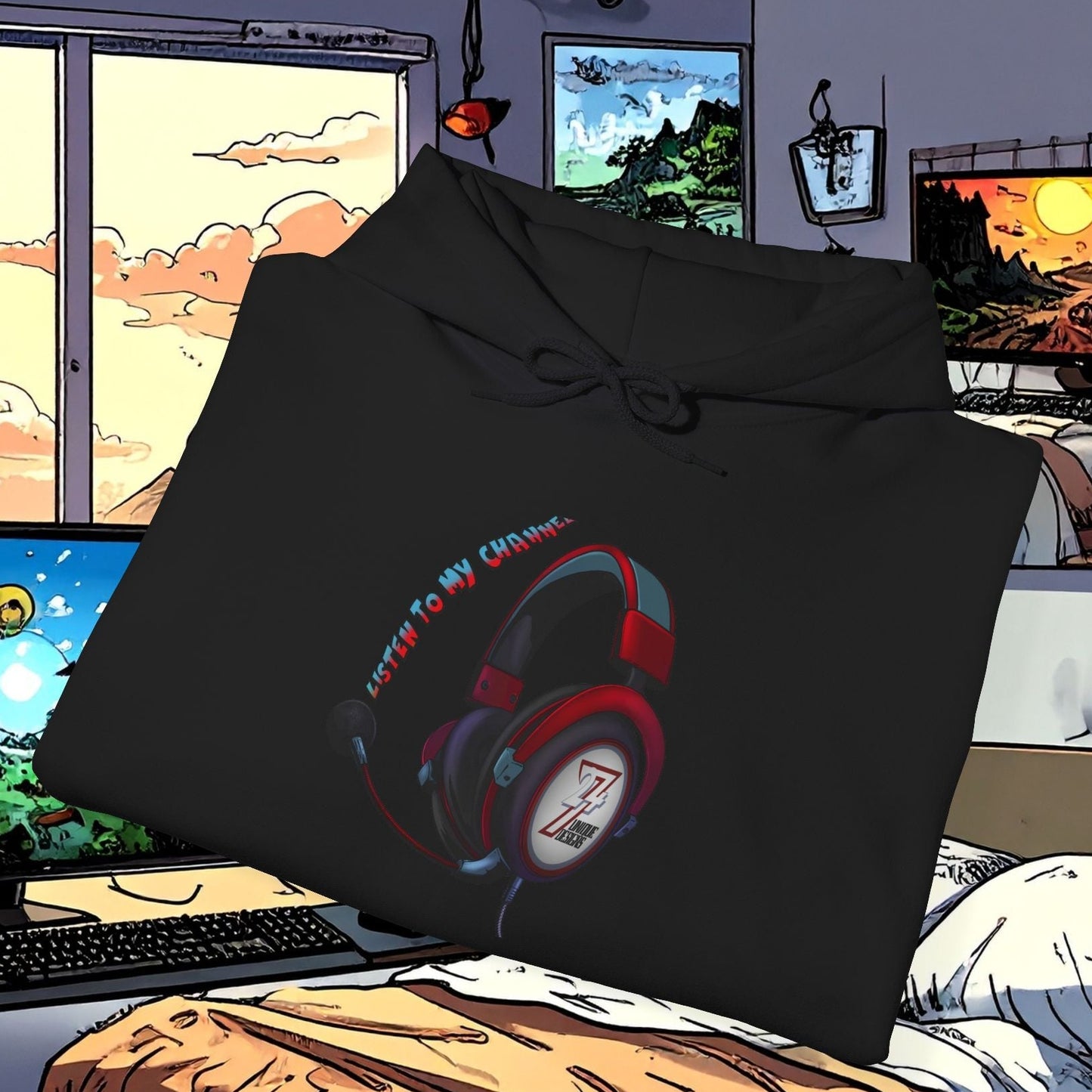 Black headset hoodie with red and black headphone design and "Listen to my channel" text, folded on bed in gaming room setting