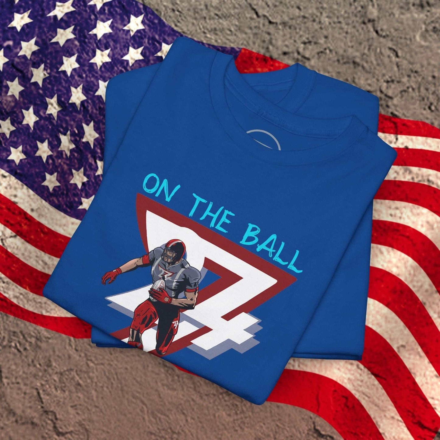 Blue American football tee with comic-style player graphic and "ON THE BALL" text