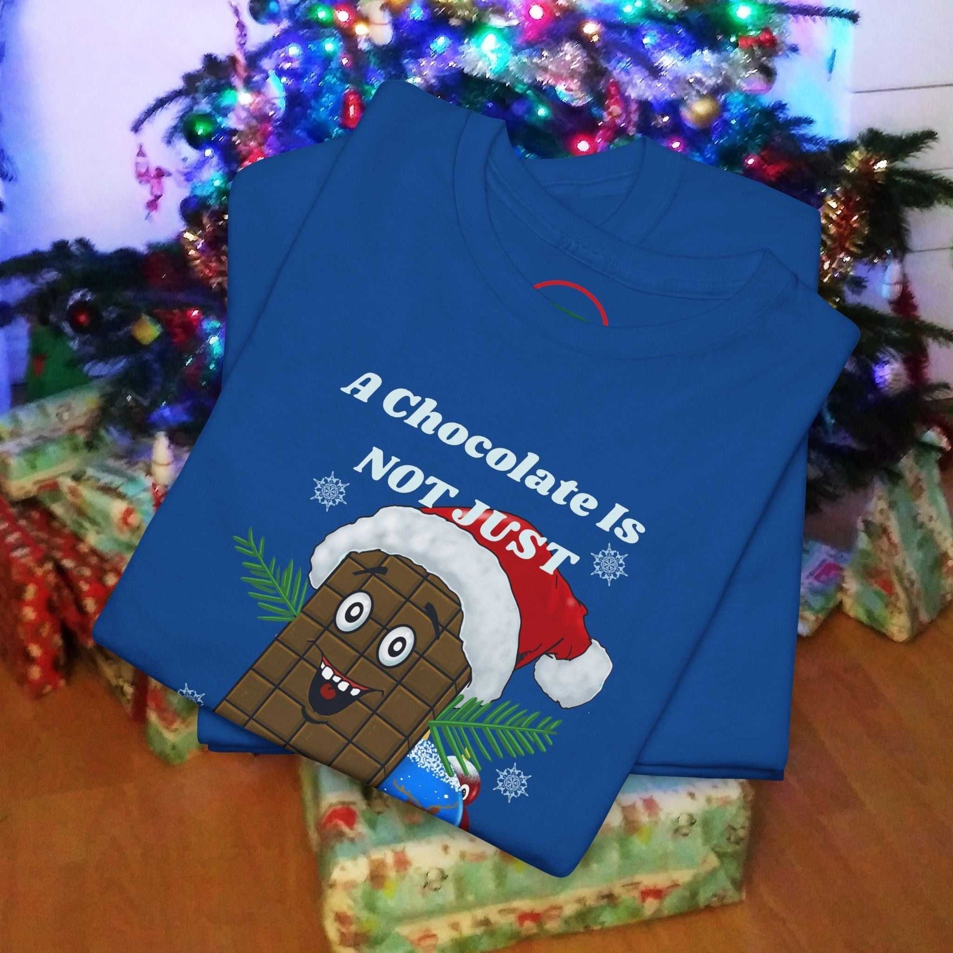 Blue Christmas tee with a smiling chocolate bar wearing a Santa hat and festive text design