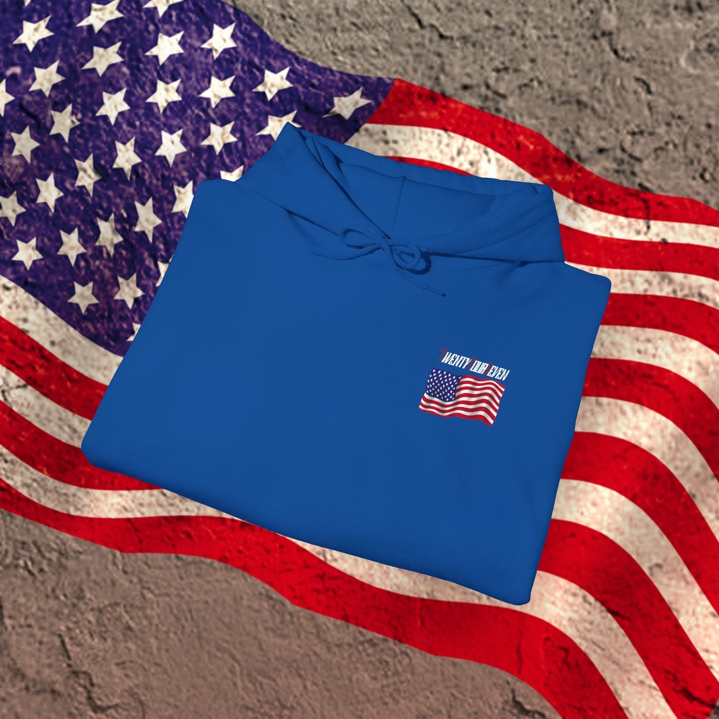 Blue US flag hoodie with small American flag design folded on American flag background